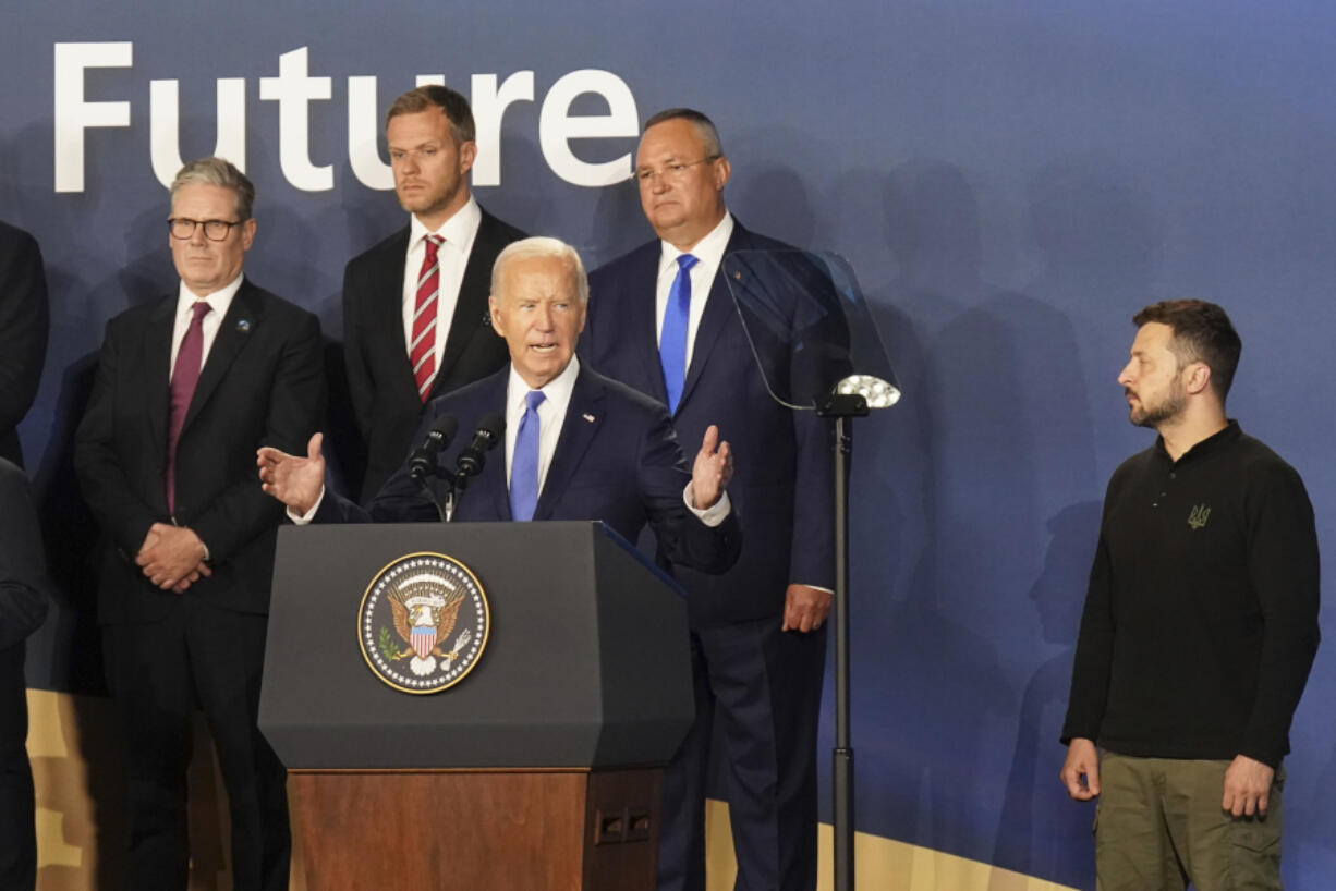 Britain&rsquo;s Prime Minister Sir Keir Starmer, left, and Ukrainian President Volodymyr Zelenskyy, right, look on as U.S. President Joe Biden speaks during an event on the Ukraine Compact at the NATO Summit at the Walter E. Washington Convention Center, in Washington, Thursday, July 11, 2024. Biden launched the Ukraine Compact, signed by 25 countries and the European Union, as part of a commitment to Ukraine&rsquo;s long term security.