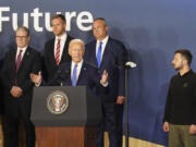 Britain&rsquo;s Prime Minister Sir Keir Starmer, left, and Ukrainian President Volodymyr Zelenskyy, right, look on as U.S. President Joe Biden speaks during an event on the Ukraine Compact at the NATO Summit at the Walter E. Washington Convention Center, in Washington, Thursday, July 11, 2024. Biden launched the Ukraine Compact, signed by 25 countries and the European Union, as part of a commitment to Ukraine&rsquo;s long term security.