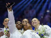 Simone Biles takes a selfie with Suni Lee, left, Hezly Rivera (blocked), Jordan Chiles and Jade Carey, right, at the United States Gymnastics Olympic Trials on Sunday, June 30, 2024, in Minneapolis.
