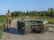 Andrii Denysenko, CEO of design and production bureau &ldquo;UkrPrototyp&rdquo;, stands by Odyssey, an 800-kilogram (1,750-pound) ground drone prototype, at a corn field in northern Ukraine, Friday, June 28, 2024. Facing manpower shortages and uneven international assistance, Ukraine is struggling to halt Russia&rsquo;s incremental but pounding advance in the east and is counting heavily on innovation at home.