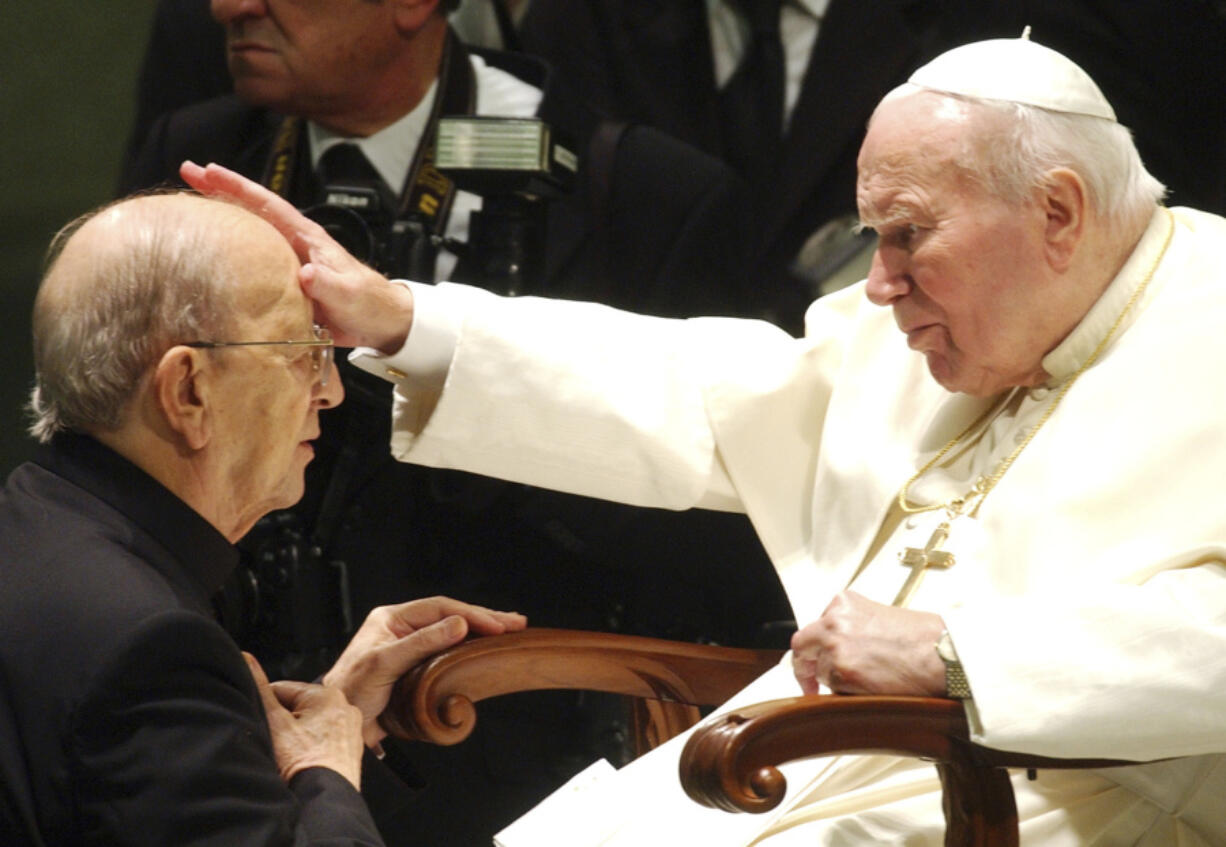 FILE - Pope John Paul II gives his blessing to late father Marcial Maciel, founder of Christ&rsquo;s Legionaries, during a special audience the pontiff granted to about four thousand participants of the Regnum Christi movement, at the Vatican, on Nov. 30, 2004. The recently-opened archives of Pope Pius XII have shed new light on claims the World War II-era pope didn&rsquo;t speak out about the Holocaust. But they&rsquo;re also providing details about another contentious chapter in Vatican history: the scandal over the founder of the Legionaries of Christ.