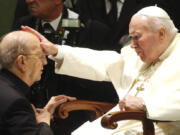 FILE - Pope John Paul II gives his blessing to late father Marcial Maciel, founder of Christ&rsquo;s Legionaries, during a special audience the pontiff granted to about four thousand participants of the Regnum Christi movement, at the Vatican, on Nov. 30, 2004. The recently-opened archives of Pope Pius XII have shed new light on claims the World War II-era pope didn&rsquo;t speak out about the Holocaust. But they&rsquo;re also providing details about another contentious chapter in Vatican history: the scandal over the founder of the Legionaries of Christ.