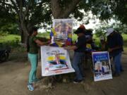 Supporters of opposition presidential candidate Edmundo Gonzalez and leader Maria Corina Machado prepare for a meeting in Sabaneta, Barinas, Venezuela, Sunday, July 7, 2024. Venezuela is set to hold a presidential election on July 28.