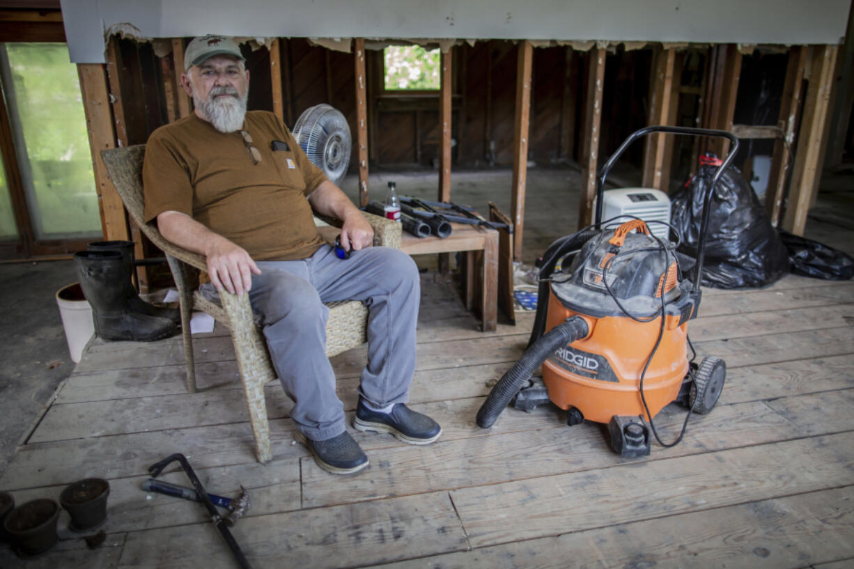 Ed Haggett, 70 poses for a portrait at his house in Montpelier, Vt., July 3, 2024, that was damaged by the 2023 flood. Haggett is waiting to hear whether the city or the Federal Emergency Management Agency will buy his home.