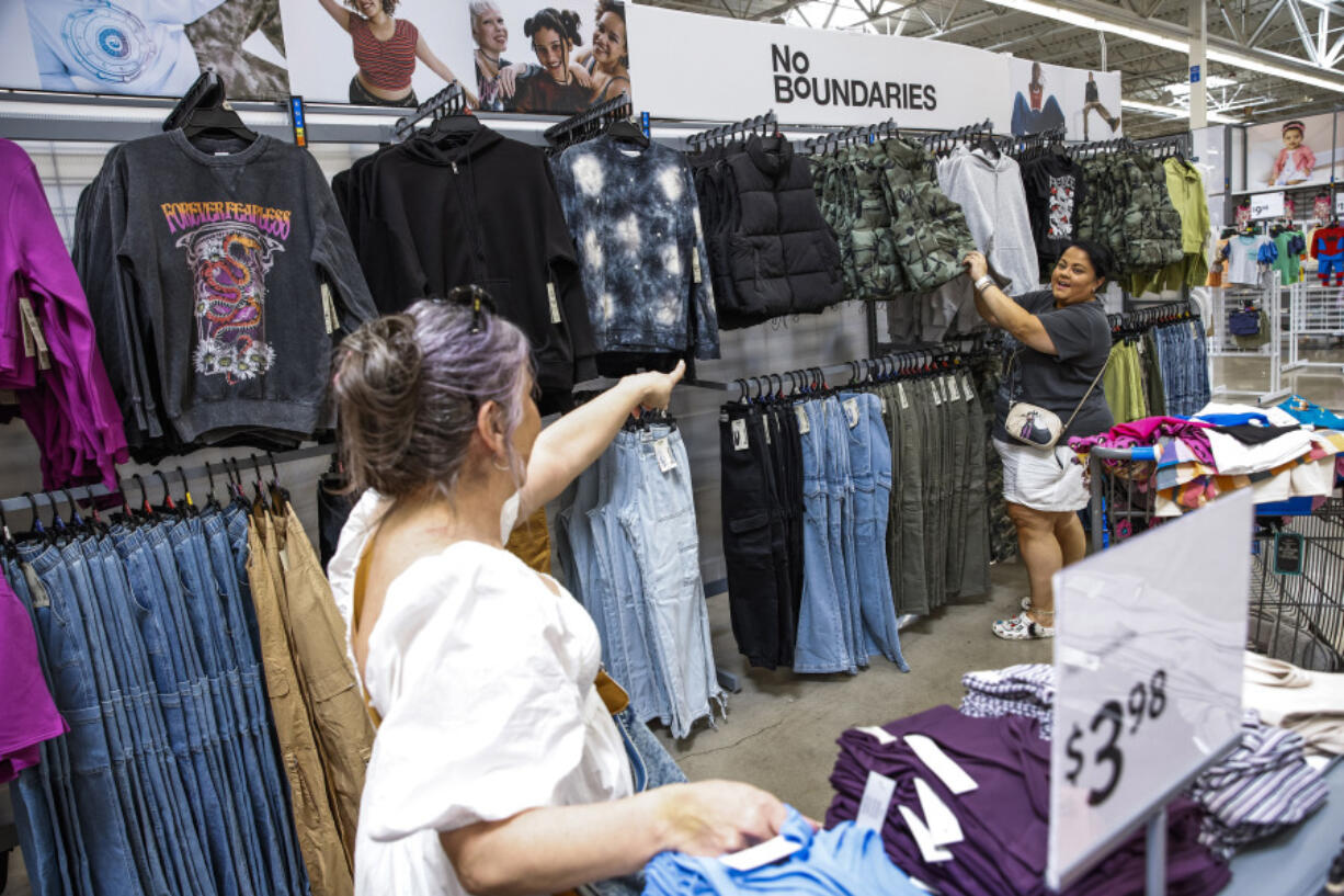 Elizabeth Hernandez, left, gestures July 11 toward her daughter Destiny Hernandez as they look at items from Walmart&rsquo;s No Boundaries collection at a Walmart Superstore in Secaucus, N.J. In hopes of resonating with younger members of Generation Z, Walmart has revamped its 30-year-old brand for teenagers and young adults.