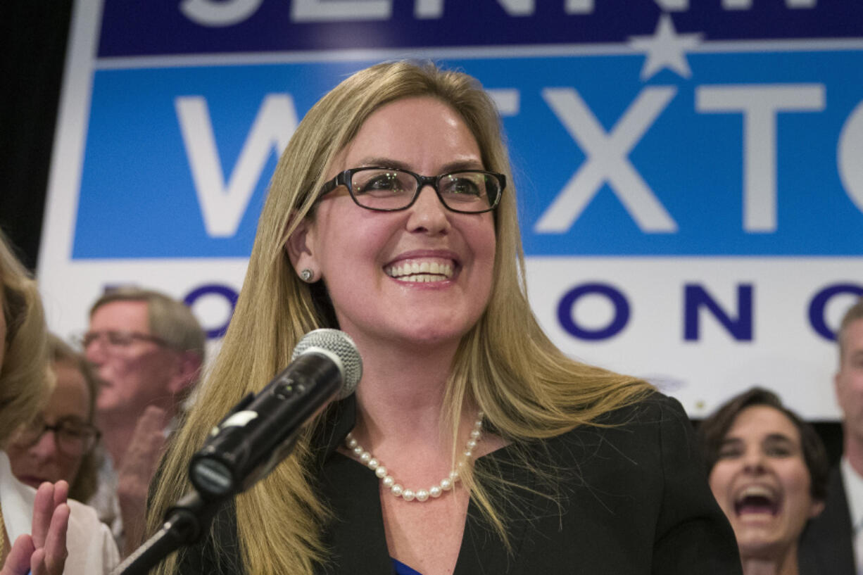 FILE - Democrat Jennifer Wexton speaks at her election night party after defeating Rep. Barbara Comstock, R-Va., Tuesday, Nov. 6, 2018, in Dulles, Va. A rare neurological disease robbed Wexton of her ability to speak clearly. But with the help of a powerful artificial intelligence program, the Virginia Democrat will use a clone of her voice to deliver what is believed to be the first speech on the House floor ever given via a voice cloned by artificial intelligence, thrusting Wexton into a broader debate about over artificial intelligence.