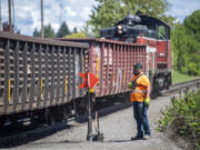 Portland Vancouver Junction Railroad conductor Brad Johnston watches as a train moves down the tracks near St. Johns Road in May 2023. The Clark County Council recently decided not to move forward with hiring a consultant to complete regulations for the section of rail line set aside for industrial development. The question of where the county goes from here remains unanswered.