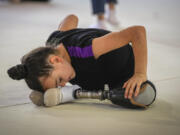 Oleksandra Paskal, an 8-year-old girl with a prosthetic leg, practices rhythmic gymnastics May 16 with other girls in Chornomorsk, Odesa region, Ukraine.