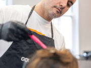 Alexey Kats, 41, works on the hair of Michelle Gillen-Doobrajh, 41, of Haddonfield, N.J., at Center City&rsquo;s Architeqt Color Bar in Philadelphia, Pa.