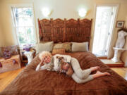 Nancy Gerrish, 78, sits on her cherished waterbed with her dog Penny on May 30 in her Los Feliz, Calif., home. Gerrish has had a waterbed for the past 28 years after first sleeping on a friend&rsquo;s waterbed.