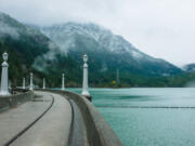 A one lane crosses a clear water dam in North Cascades National Park, east of Mount Baker.