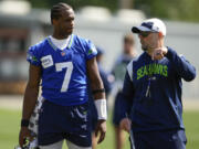 Seattle Seahawks quarterback Geno Smith says new offensive coordinator Ryan Grubb, right, has developed an offense that can stretch the field or give options for shorter success.