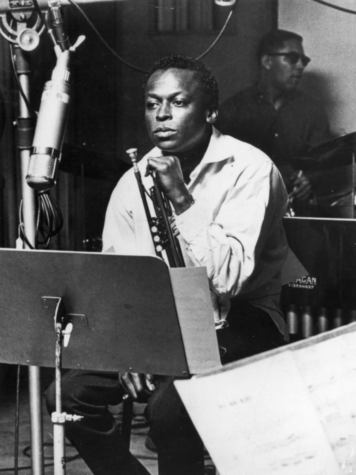 American jazz trumpeter and composer Miles Davis sits with his instrument during a studio recording session in October 1959.