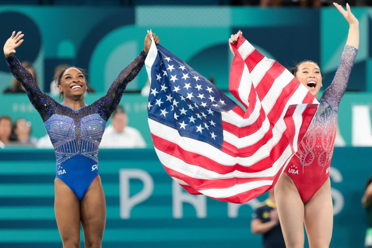 Simone Biles, left, celebrates with Suni Lee after winning gold and bronze respectively during the women&rsquo;s all-around gymnastic final Aug. 1 during the 2024 Summer Olympics at Bercy Arena in Paris.