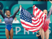 Simone Biles, left, celebrates with Suni Lee after winning gold and bronze respectively during the women&rsquo;s all-around gymnastic final Aug. 1 during the 2024 Summer Olympics at Bercy Arena in Paris.