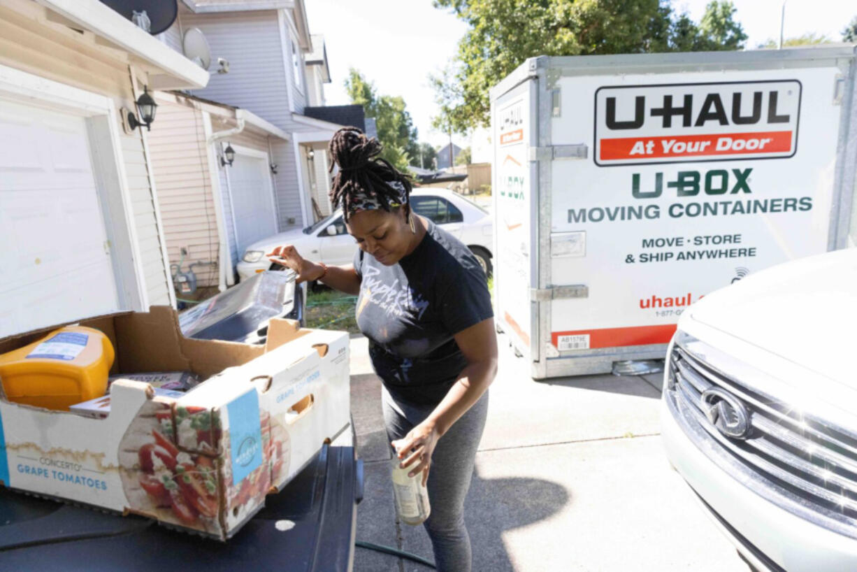 ShaWayne Hodges takes out recycling while sorting and packing at her Vancouver, WA home on Wednesday, July 31, 2024.