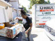 ShaWayne Hodges takes out recycling while sorting and packing at her Vancouver, WA home on Wednesday, July 31, 2024.