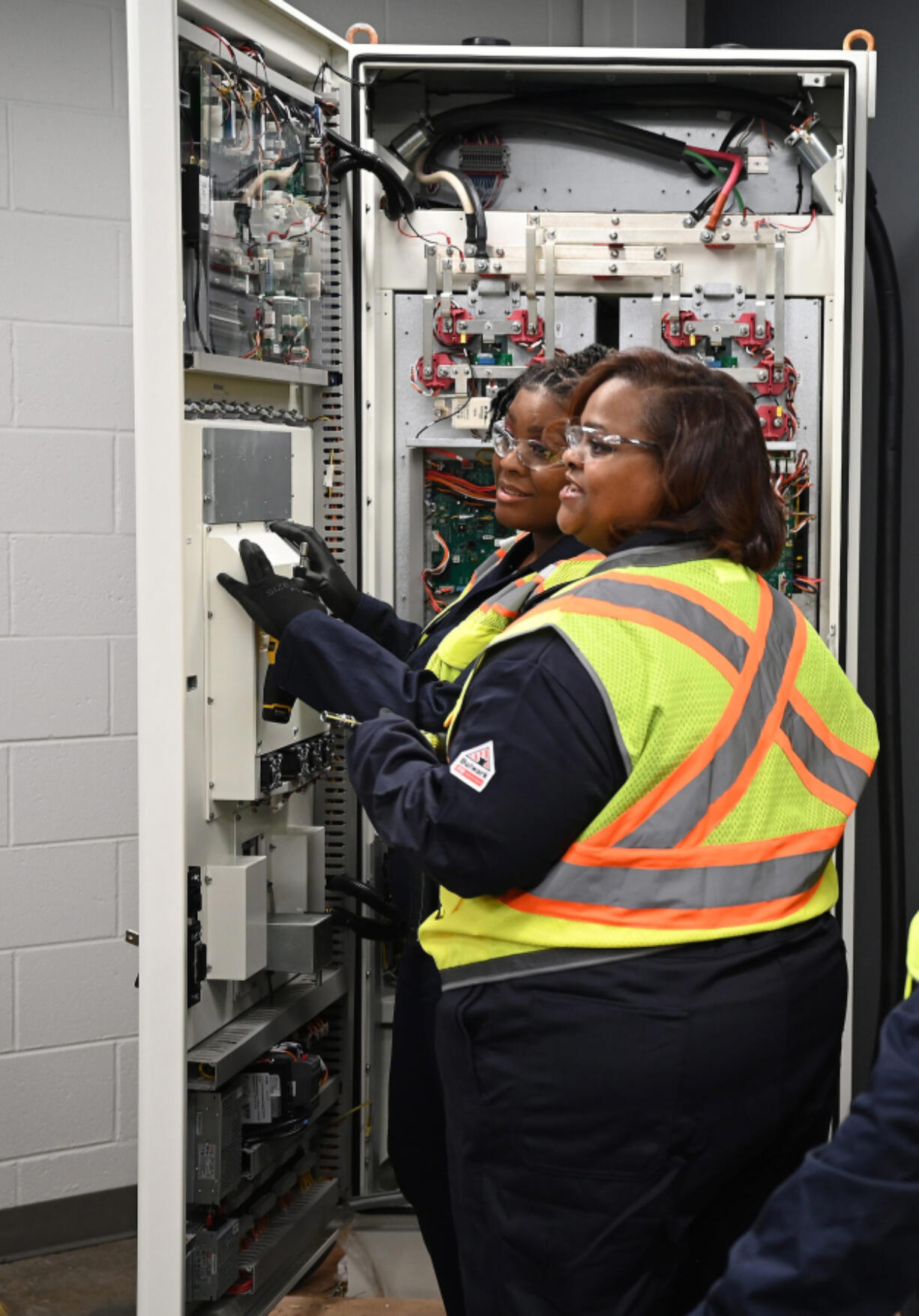 Detroiters Juliette Johnson, foreground, and Hayley Merriweather graduated last month from a Goodwill-sponsored program that&rsquo;s among efforts to train more technicians to maintain and repair electric vehicle chargers.