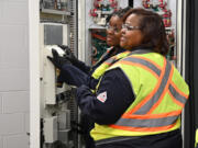 Detroiters Juliette Johnson, foreground, and Hayley Merriweather graduated last month from a Goodwill-sponsored program that&rsquo;s among efforts to train more technicians to maintain and repair electric vehicle chargers.