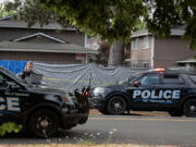 First responders work at the scene after a shooting left two people dead in central Vancouver on July 25.