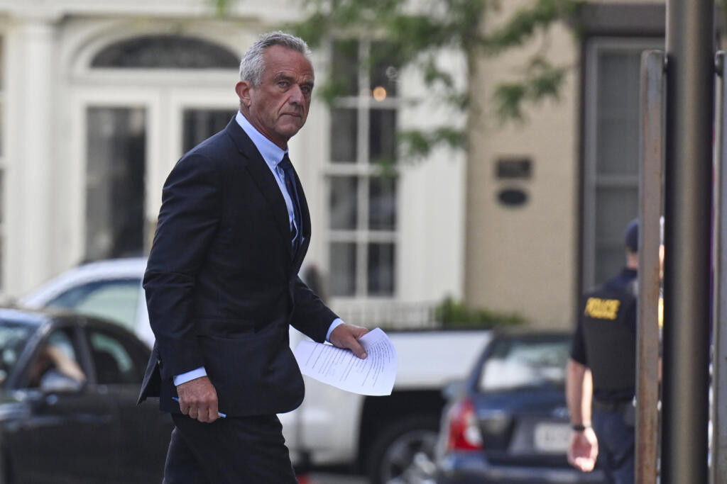 Independent presidential candidate Robert F. Kennedy Jr., right, arrives at the Albany County Courthouse to fight a lawsuit he falsely claimed to live in New York state, Wednesday, Aug. 7, 2024, in Albany, N.Y.