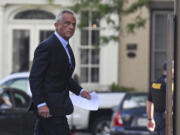 Independent presidential candidate Robert F. Kennedy Jr., right, arrives at the Albany County Courthouse to fight a lawsuit he falsely claimed to live in New York state, Wednesday, Aug. 7, 2024, in Albany, N.Y.