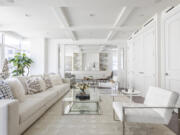 Various shades of white including a winter white sofa and area rug helps to create a look that is crisp and clean.