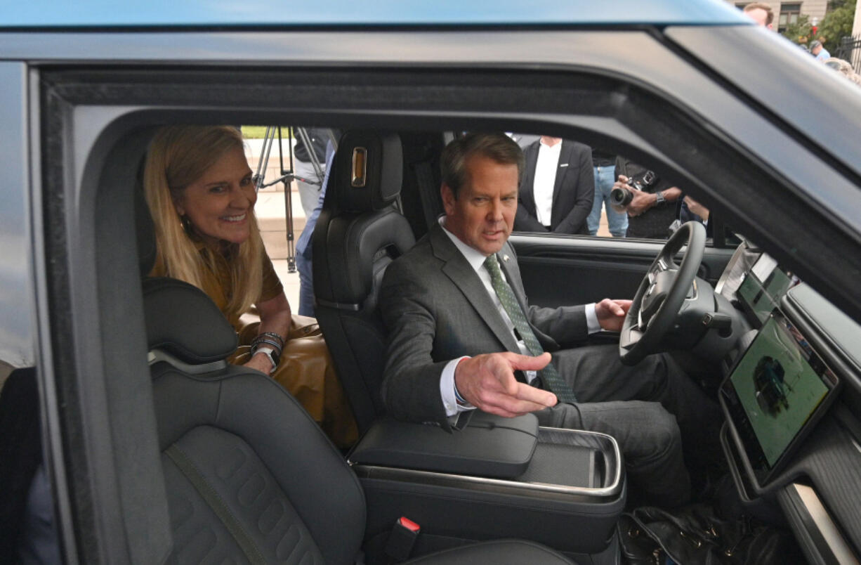 December 16, 2021 Atlanta - Georgia Governor Brian Kemp and First Lady Marty Kemp react as they sit inside Rivian R1T electric truck during a press conference at Liberty Plaza across from the Georgia State Capitol in Atlanta on Dec 16, 2021.