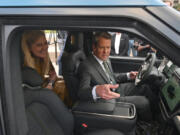 December 16, 2021 Atlanta - Georgia Governor Brian Kemp and First Lady Marty Kemp react as they sit inside Rivian R1T electric truck during a press conference at Liberty Plaza across from the Georgia State Capitol in Atlanta on Dec 16, 2021.