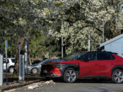 An electric vehicle charges at the electric charging station at Clark Public Utilities in April. Several consumers say they have had trouble redeeming the state&rsquo;s new EV rebate.