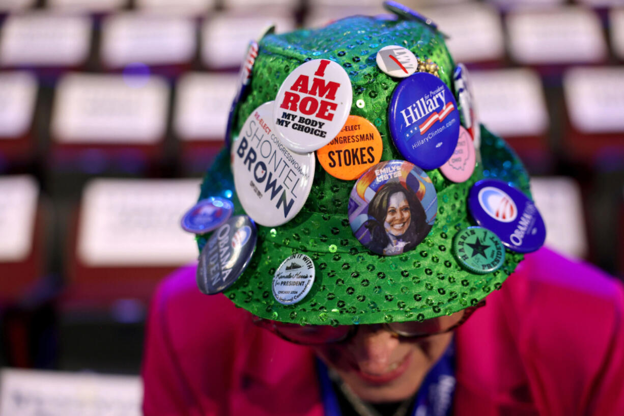 Ohio celebration committee member Helen Sheehan shows her hat with political buttons on the floor of the 2024 Democratic National Convention on Monday in Chicago.