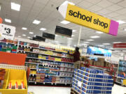 A worker stocks shelves of back-to-school supplies at a Target store in Colma, Calif.