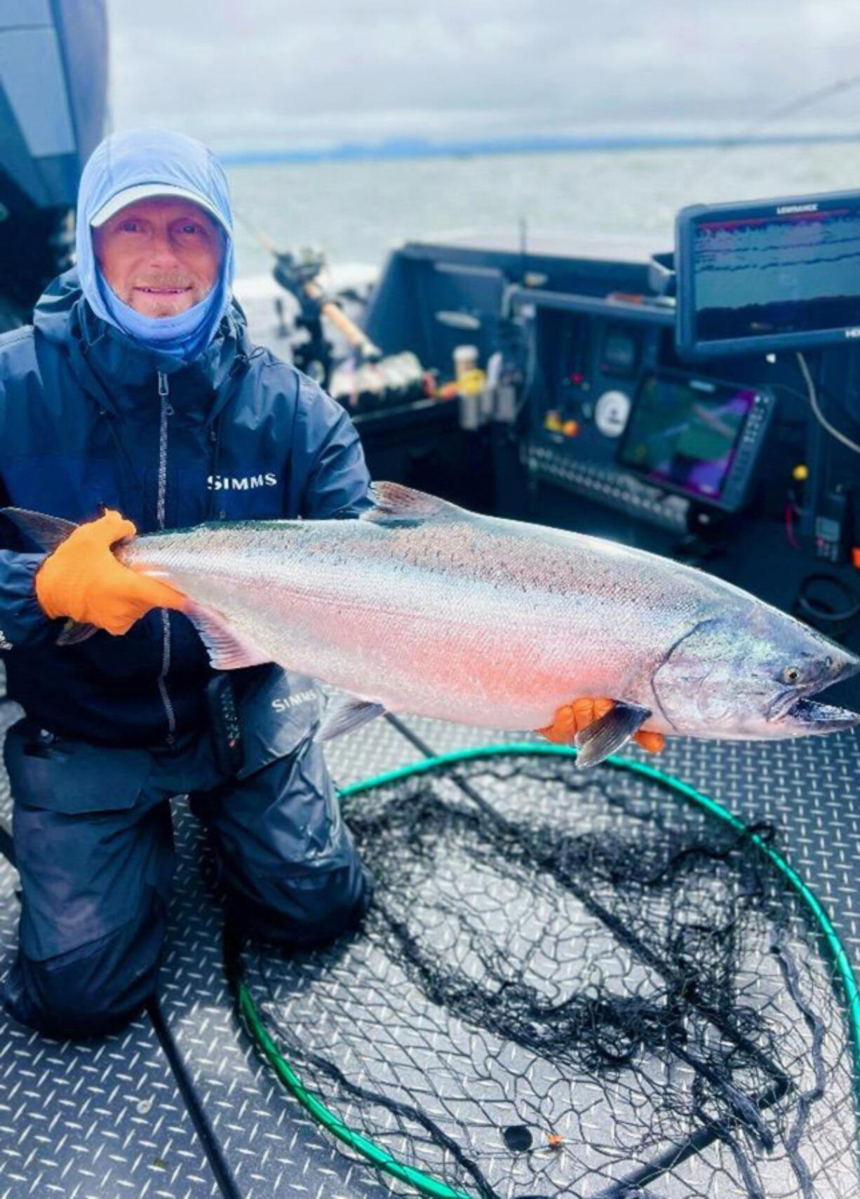 Fishing Guide Bill Monroe shows off a very nice Buoy 10 hatchery clipped fall Chinook. While the mark rate has been low in the mark-selective fishery, Monroe has found success with bait-filled plugs.