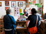 Tamera Mickelson, a retail associate and working artist, checks out customers Aug. 16 at Seattle ReCreative, a nonprofit organization, in Greenwood.