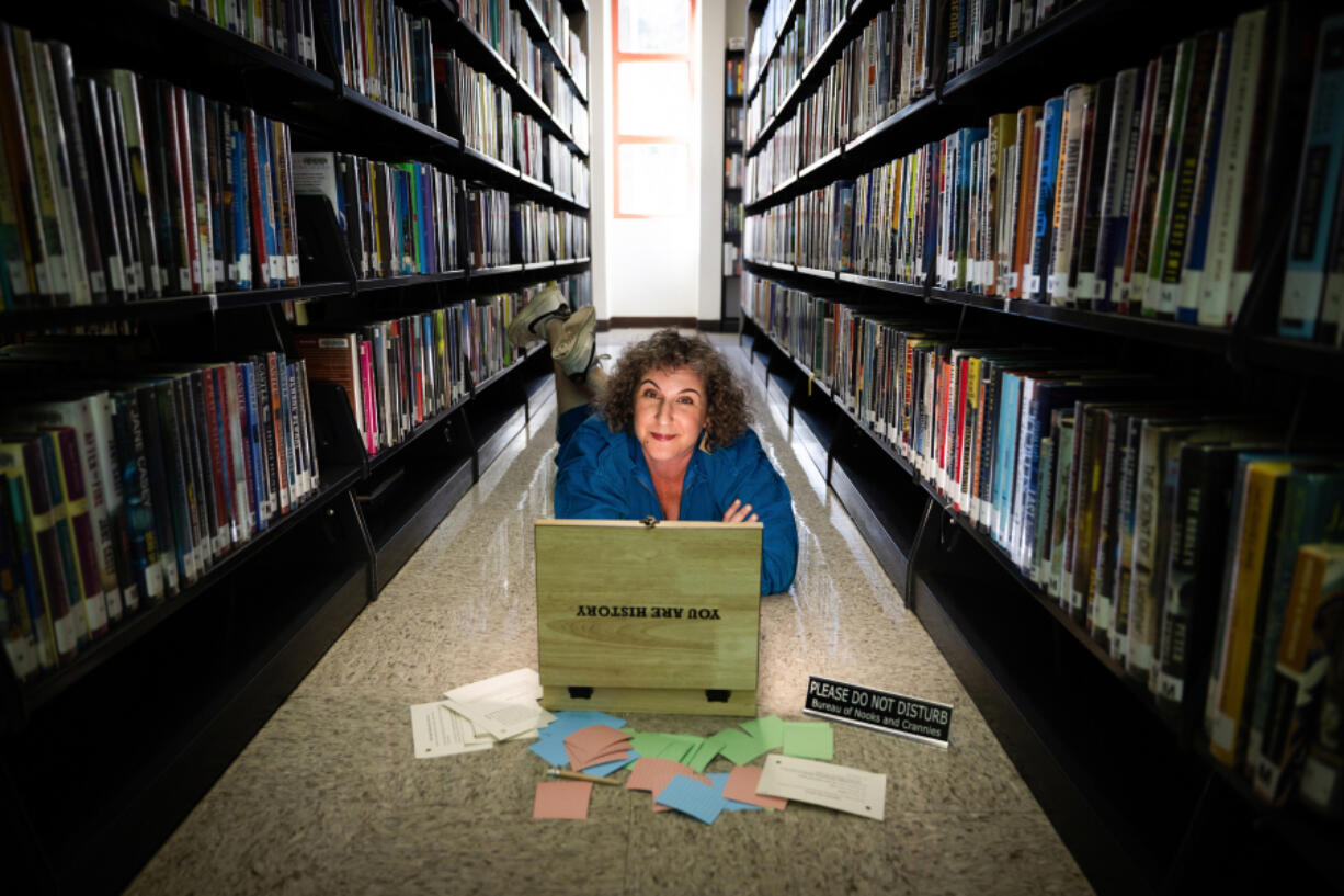 Puzzle designer Andy Crocker, a local game designer/theatrical director, poses Aug. 3 with the immersive puzzle at the Atwater Village branch library in Los Angeles. (Photos by Allen J.