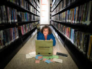 Puzzle designer Andy Crocker, a local game designer/theatrical director, poses Aug. 3 with the immersive puzzle at the Atwater Village branch library in Los Angeles. (Photos by Allen J.