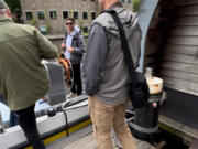 American tourists board a boat for a ride through the canals of Amsterdam on July 5. Local residents throughout Europe say they are looking for more respect and fewer demands from the increasing number of visitors.