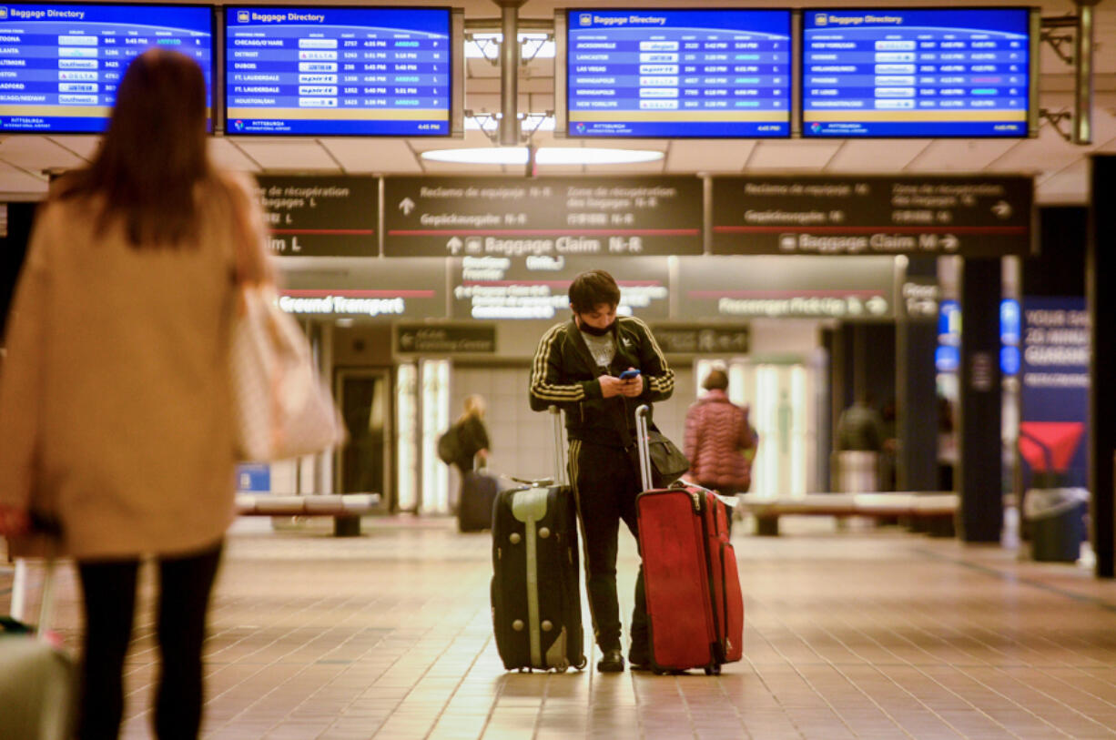 A traveler waits for a ride at Pittsburgh International Airport on Nov. 8, 2021. The Biden administration&Ccedil;&fnof;&Ugrave;s Bipartisan Infrastructure Law opened the way for the smaller, regional airport to receive a full $1.5 billion for upgrades and improvements.