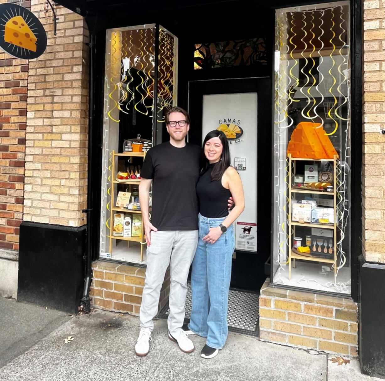 Andy and Tiffany Regan stand in front of their newly opened Camas Cheese Co. shop at 231 N.E. Fourth Ave., in downtown Camas earlier this month.