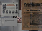 The Zekelman Holocaust Center Director of Education Ruth Bergman, seen through a display, during a tour in Farmington Hills, Michigan, on Aug. 7, 2024.