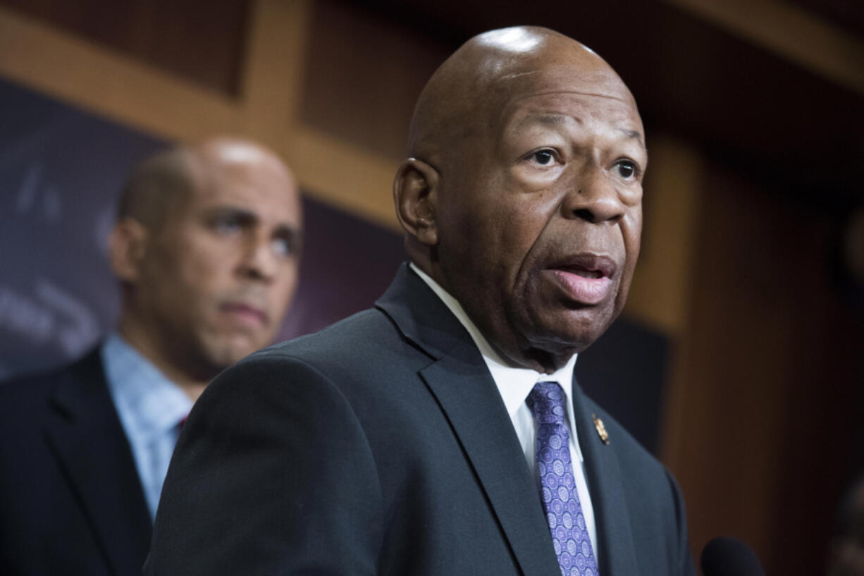 In a file photo from Jan. 10, 2019, Rep. Elijah Cummings, D-Md., right, and Sen. Cory Booker, D-N.J., conduct a news conference in the Capitol to introduce a legislative package that would lower prescription drug prices in the U.S.