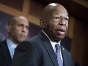 In a file photo from Jan. 10, 2019, Rep. Elijah Cummings, D-Md., right, and Sen. Cory Booker, D-N.J., conduct a news conference in the Capitol to introduce a legislative package that would lower prescription drug prices in the U.S.