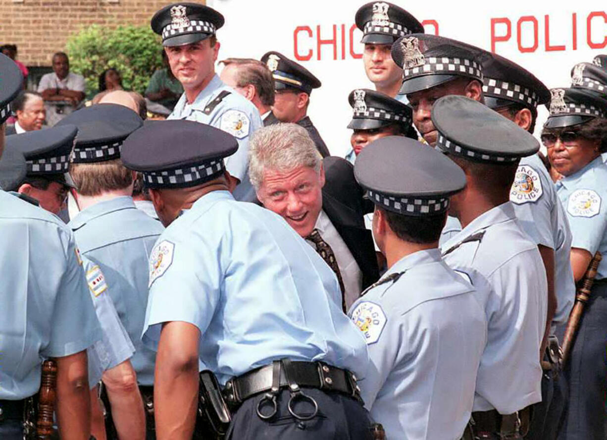 Then-President Bill Clinton, center, greets newly hired Chicago police officers on June 30, 1995, during an award ceremony for Clinton given by the Illinois Council Against Handgun Violence in Chicago. The officers were hired with federal funds from Clinton&Ccedil;&fnof;&Ugrave;s Crime Bill. (Paul J.