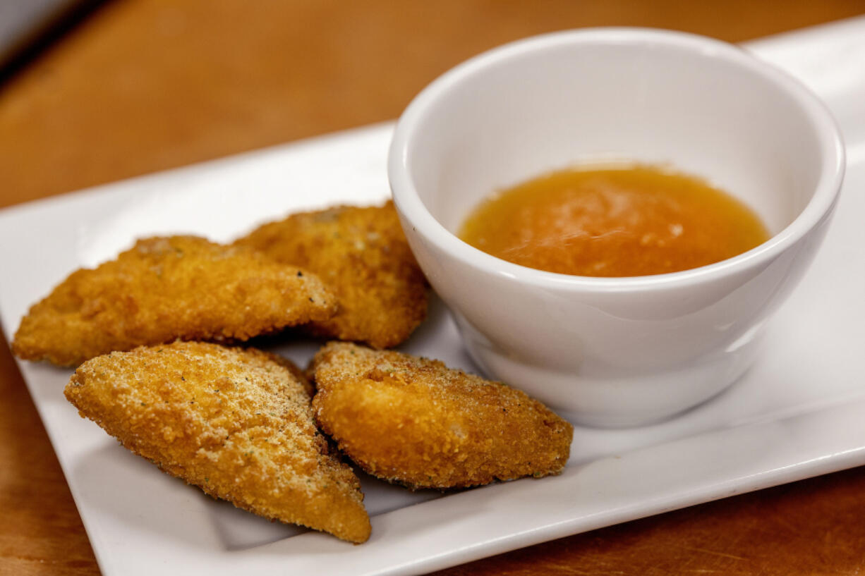 Max Burrows, the general manager of The Clover, makes deep-fried ranch dressing, one of the new Minnesota State Fair foods, in Rosemount, Minn.