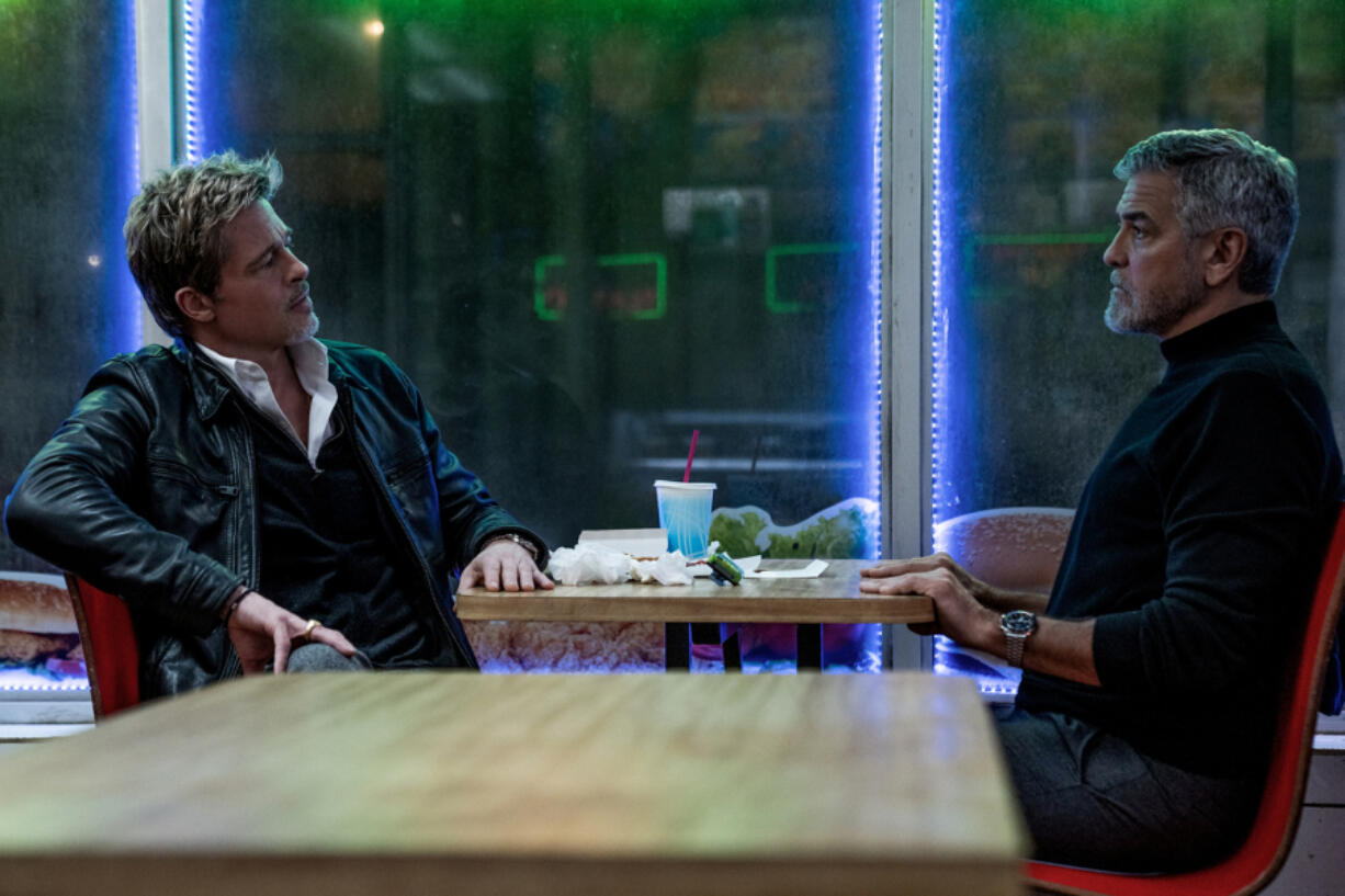 Brad Pitt, left, and George Clooney in &Ccedil;&fnof;&uacute;Wolfs,&Ccedil;&fnof;&ugrave; which lands on Apple TV+ Sept. 27, a week after receiving a limited theatrical release.