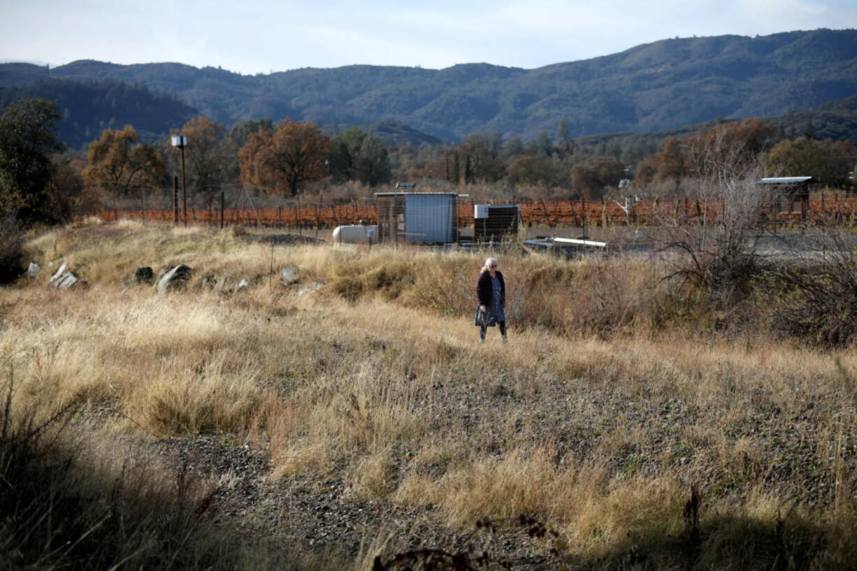 A woman walks in the dry Adobe Creek in Kelseyville in December 2022.