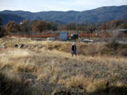 A woman walks in the dry Adobe Creek in Kelseyville in December 2022.