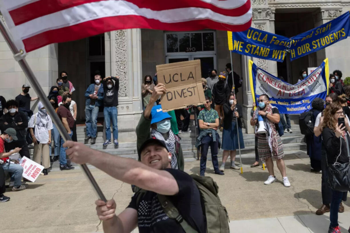 Pro-Israel protesters wave an American flag during a pro-Palestinian protest at UCLA in May.