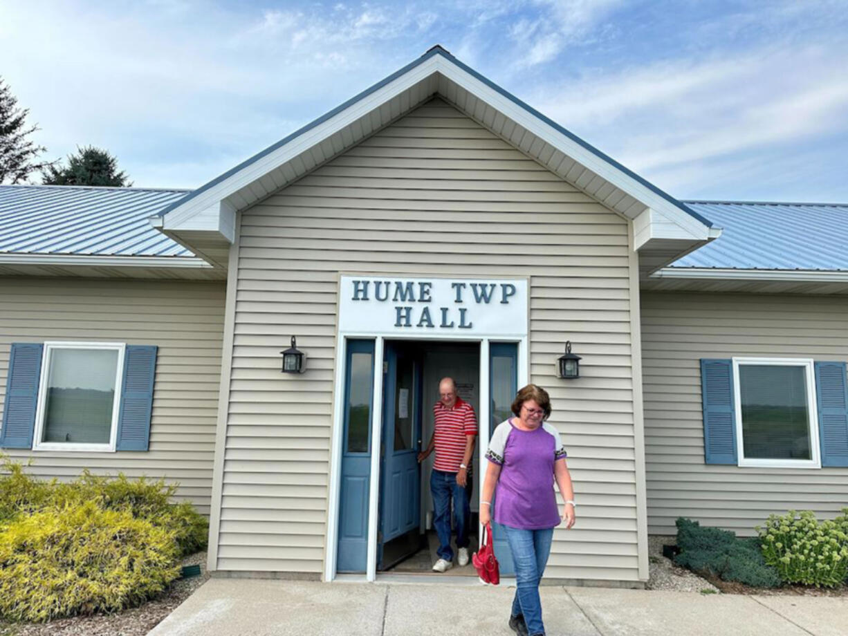 Lincoln Township Clerk Irvin Kanaski, left, and Hume Township Clerk Theresa Mazure leave an early voting site on Aug. 1, 2024, in Port Austin, Michigan.