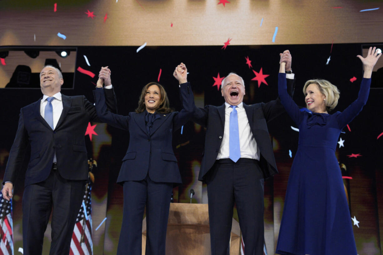 Vice President and Democratic presidential nominee Kamala Harris stands with second gentleman Doug Emhoff, left, vice presidential nominee Minnesota Governor Tim Walz and his wife Gwen Walz, right, following Harris&rsquo; acceptance speech at the Democratic National Convention in Chicago, on Aug. 22, 2024.